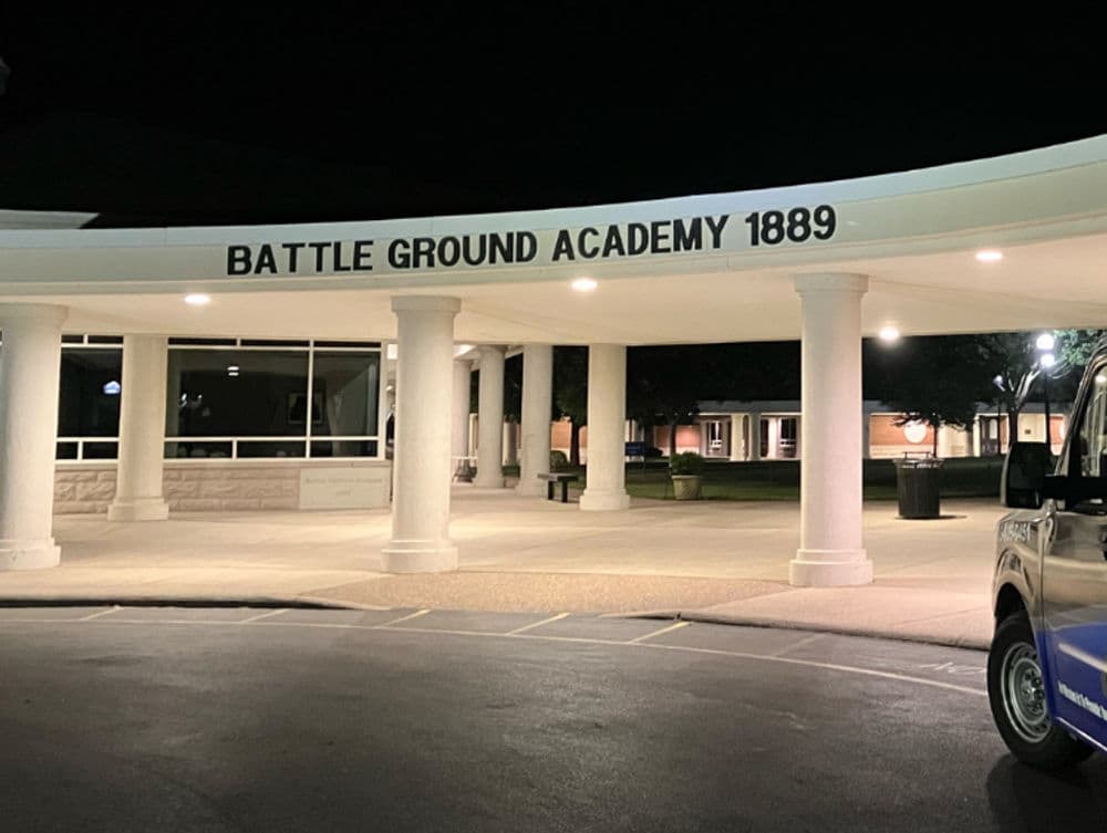 Battle Ground Academy entrance at night, showcasing columns and illuminated signage 1889.