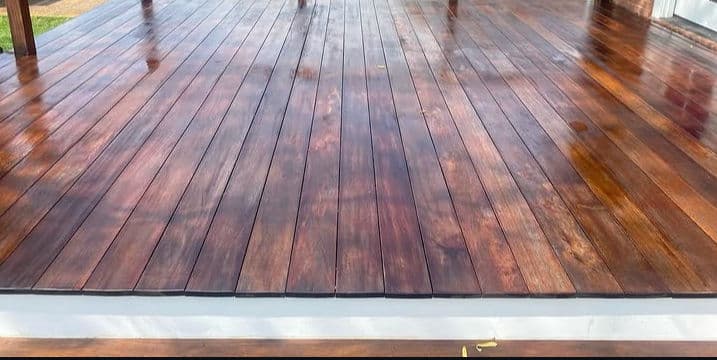 Shiny wooden deck with rich brown tones and smooth finish under natural light.