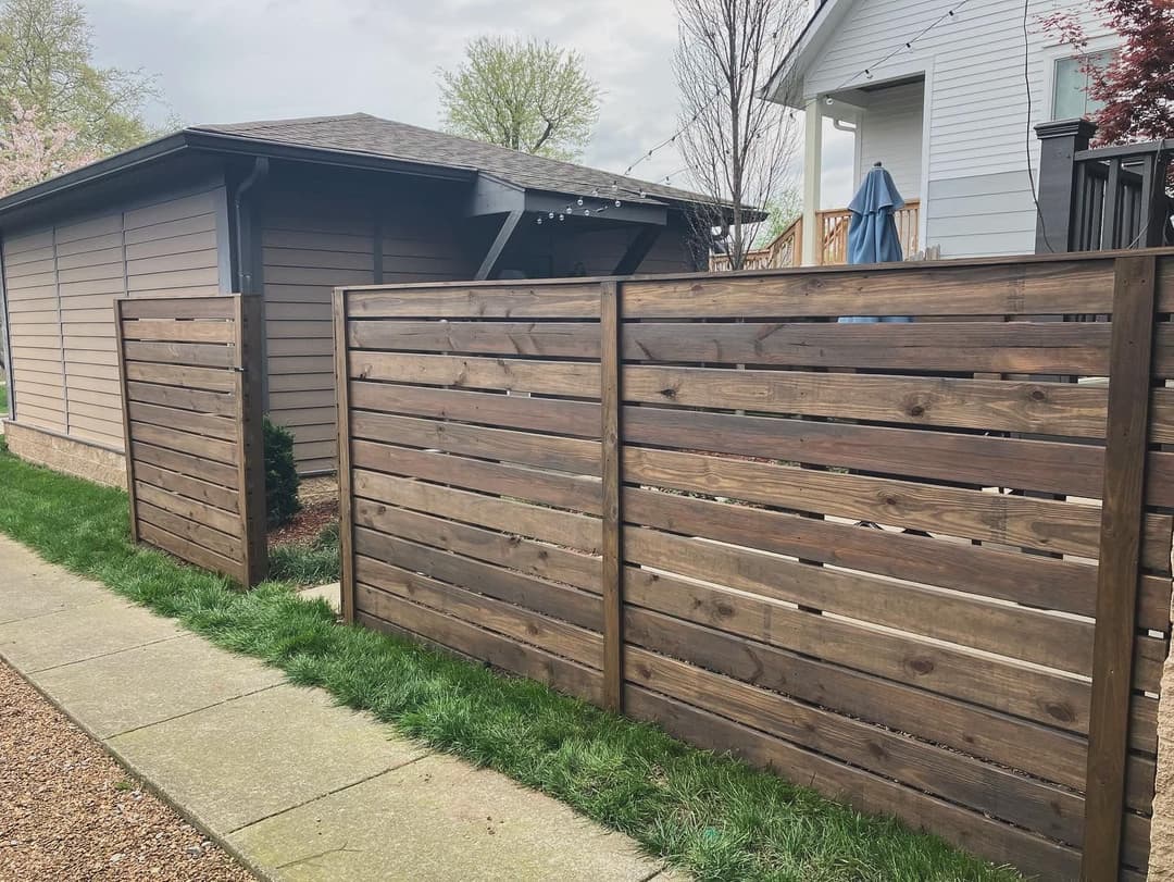 Wooden fence panels in a residential area, enhancing privacy and outdoor aesthetics.